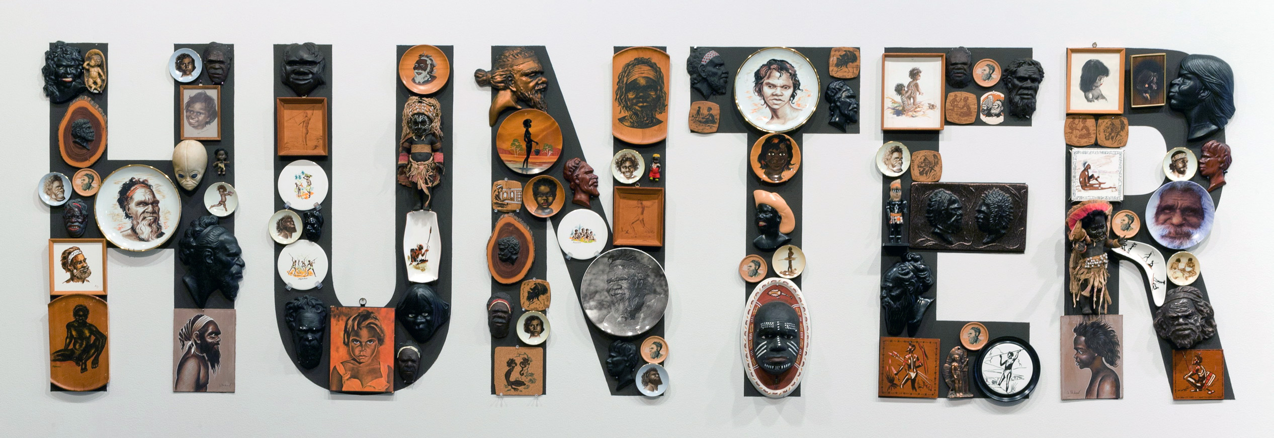 The word 'Hunter' in black capital letters on which are numerous objects depicting Aboriginal people