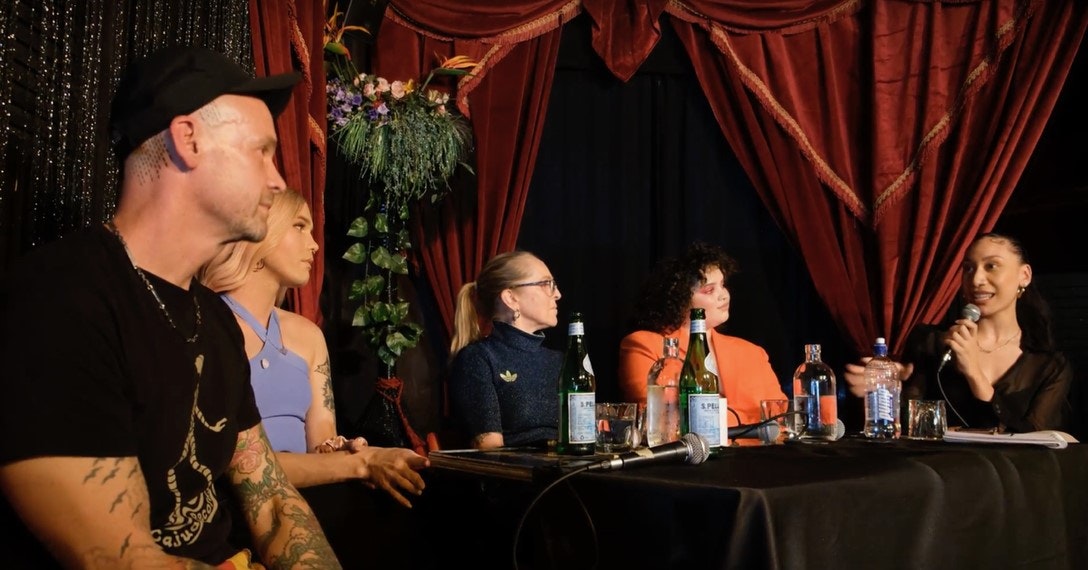 A group of five people seated along a table.