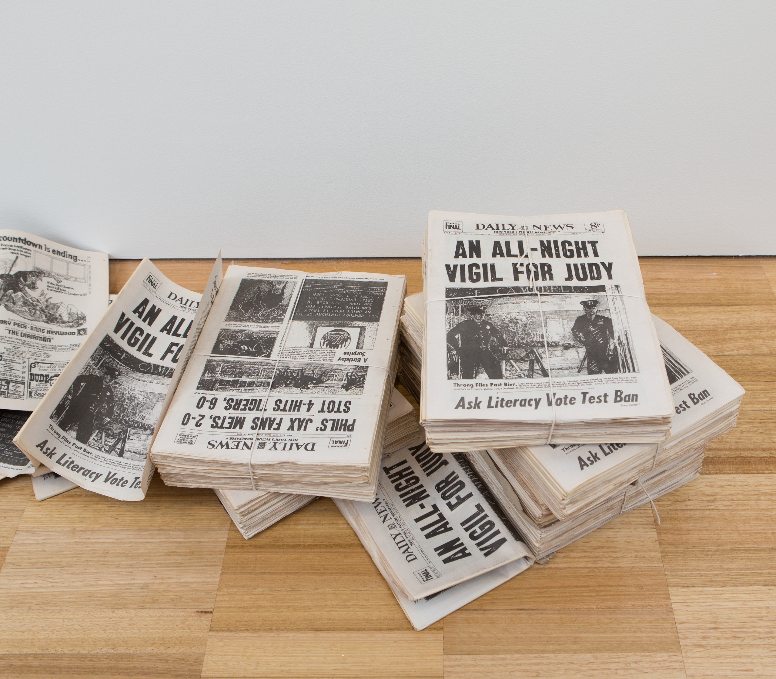 A pile of newspapers with the headline 'An all-night vigil for Judy'.
