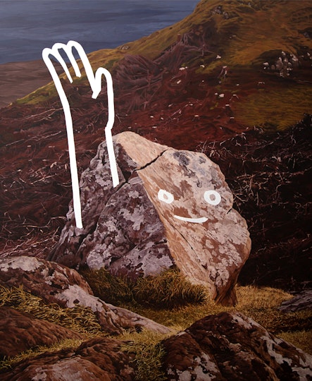 A smiley face and raised arm overpainted on a rock in a landscape