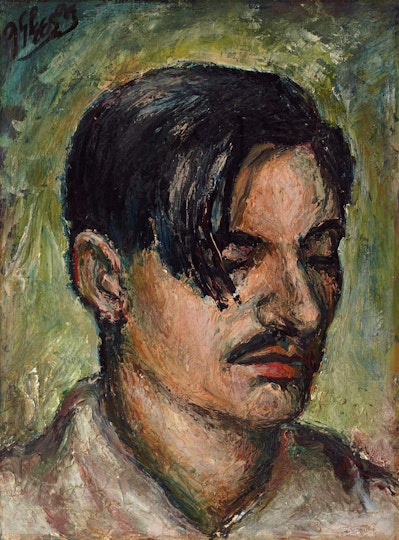The head of a person with short dark hair and a moustache