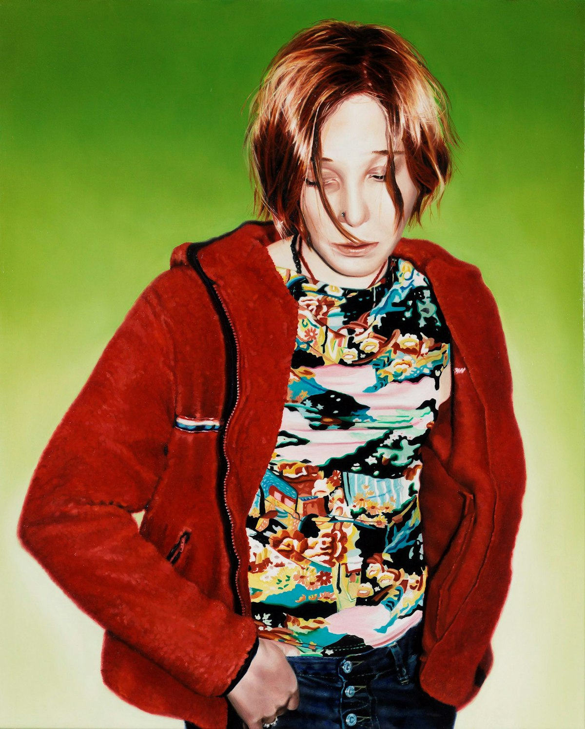 A person with orange hair wearing a red jacket, patterned top and buttoned jeans, stands against a green background