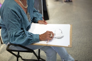 A visitor drawing in the Art Gallery of New South Wales