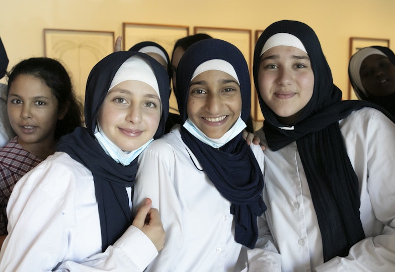 Four smiling students in uniform