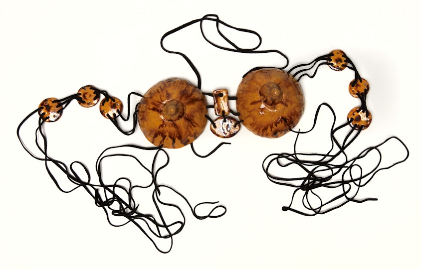 Two large domed objects and several smaller objects joined by string