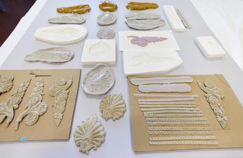 Many decorative shapes in various colours and materials on a table