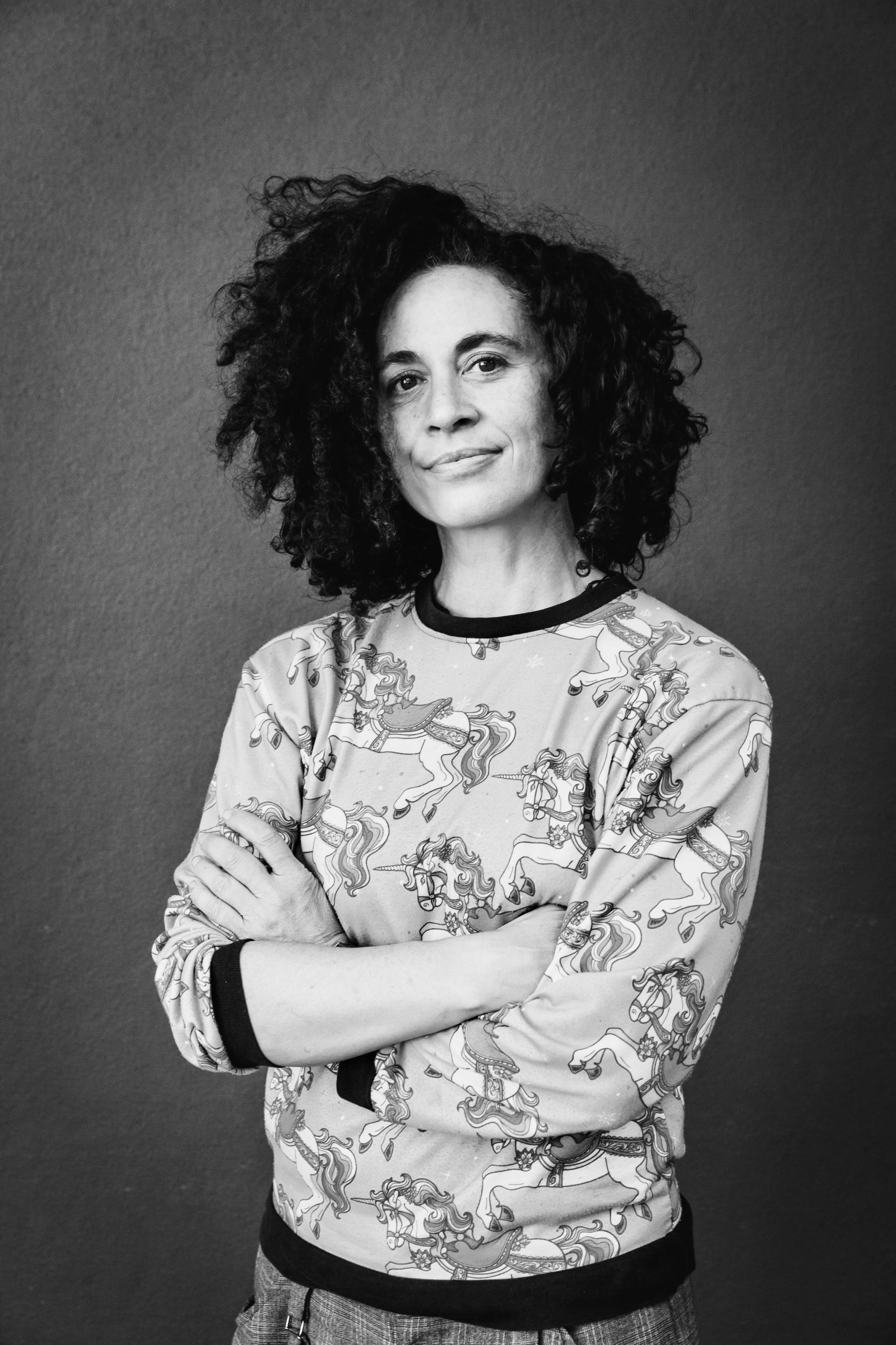 A person standing with their arms crossed