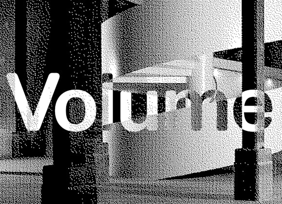 The word Volume superimposed on a grainy image of a spiral staircase and concrete columns.