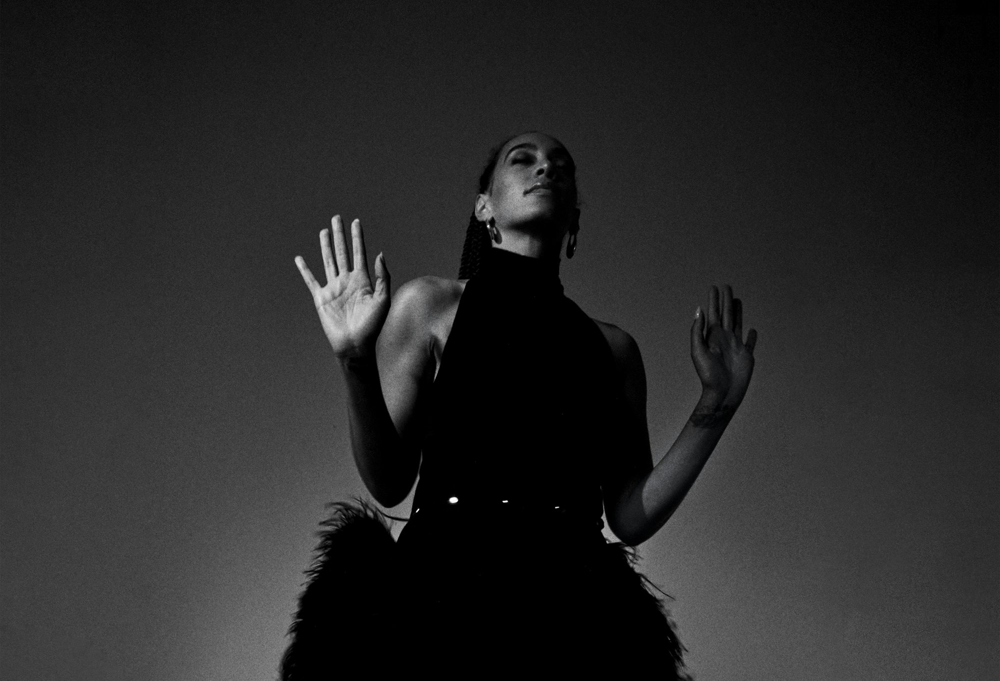 A person with their hands held in front of them at shoulder height, palms forward