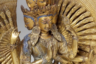 A multi-armed, many-faced figure sculpture