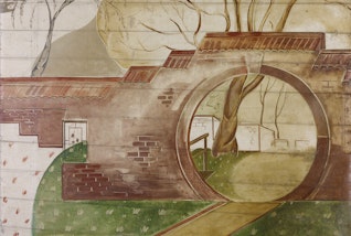 A garden with a wall that includes a circular entranceway