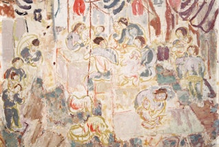 Many people in a garden setting, some sitting on tables