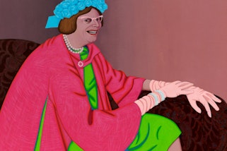 A seated person in a green dress, pink coat, blue hat, gloves, pearles and glasses