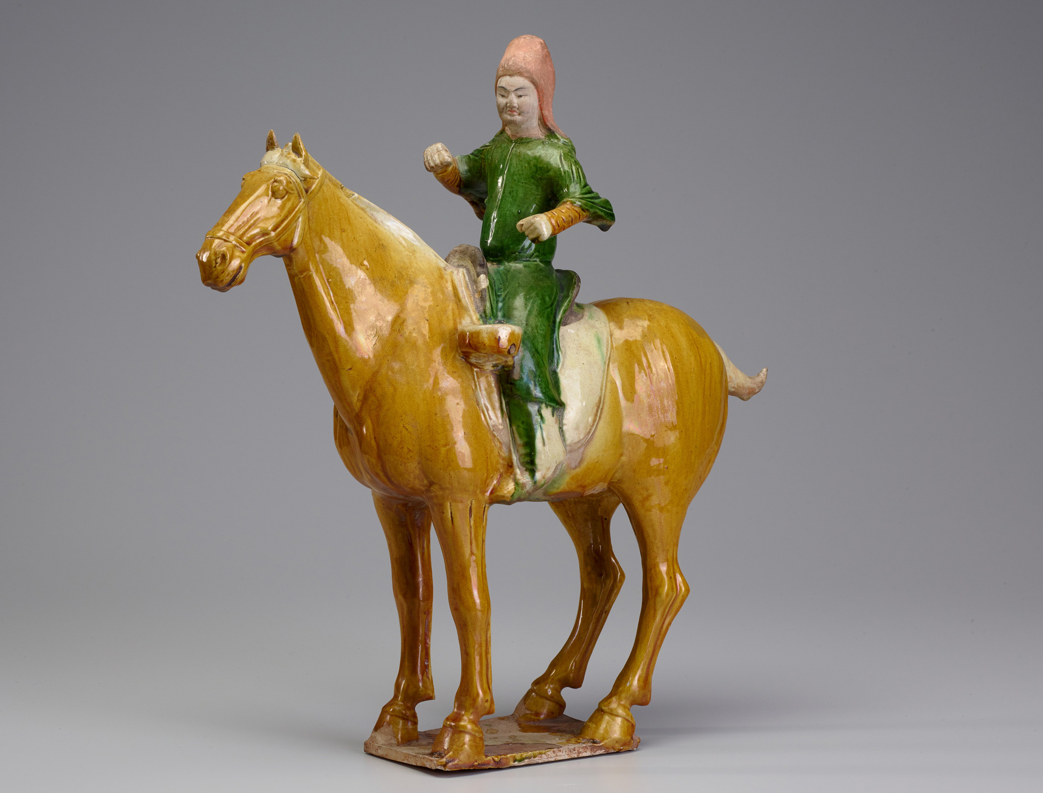 A ceramic sculpture of a person on a horse