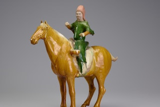 A ceramic sculpture of a person on a horse