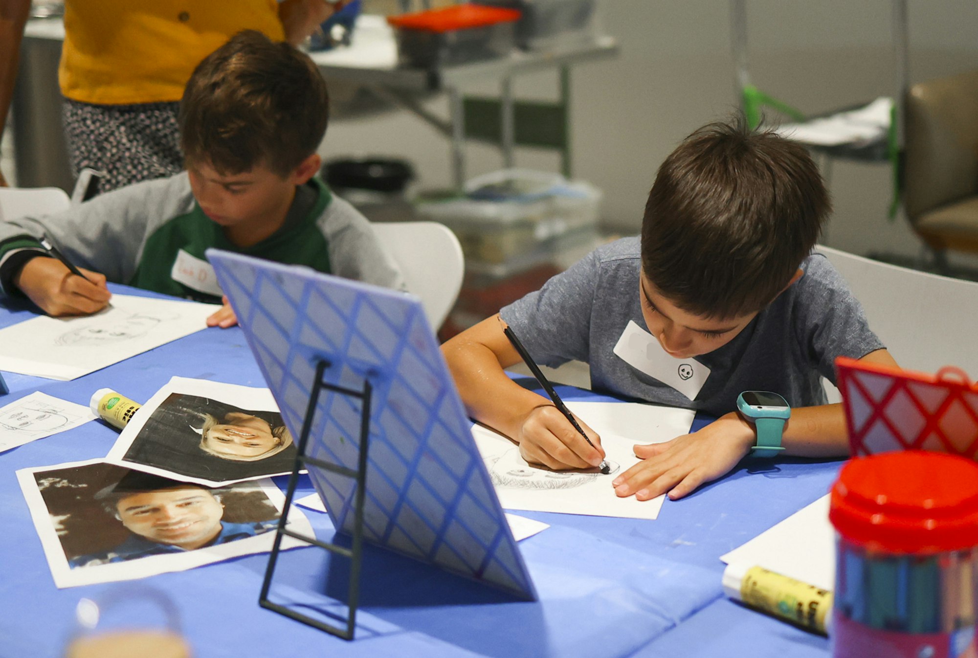 Two children drawing at a table