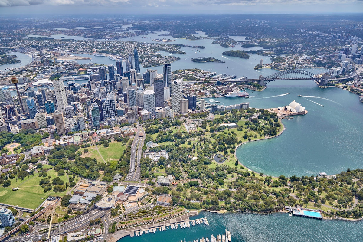 Skyscrapers surrounded by smaller buildings, parklands and harbour bays