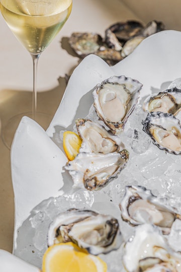 A plate of oysters and a glass of sparkling wine