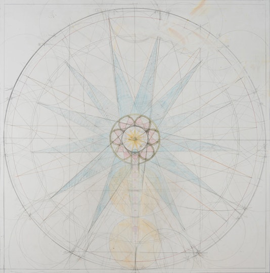 A pencil drawing of a circle in which there are ruled lines, a small central flower-like shape and a large star-like shape.