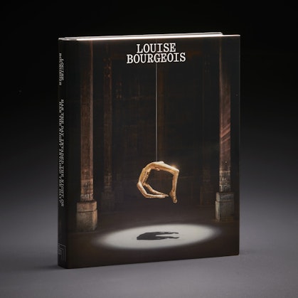 A book with the title Louise Bourgeois and an image of a gold suspended figure sculpture