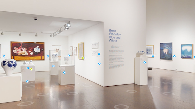 The Brett Whiteley Studio entrance space with artworks on walls and on plinths. There are circles overlaid at spaces on the floor and on the plinths.