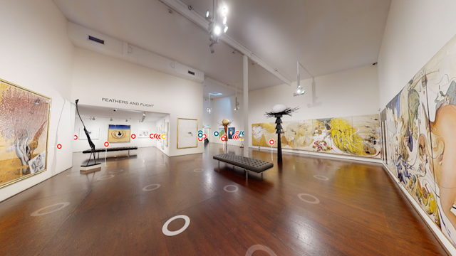The Brett Whiteley Studio entrance space with paintings on walls and sculptures on plinths. There are circles overlaid at spaces on the floor and on the plinths.