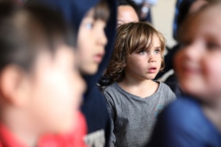 A group of young children with the focus on one child in the centre