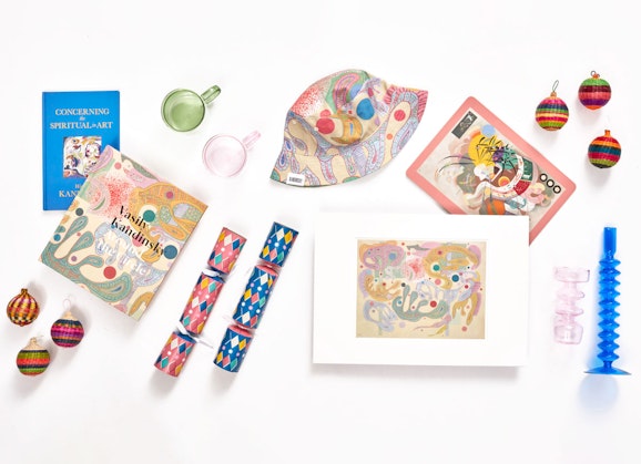 A selection of items including books, prints, glassware, a hat, baubles and Christmas crackers
