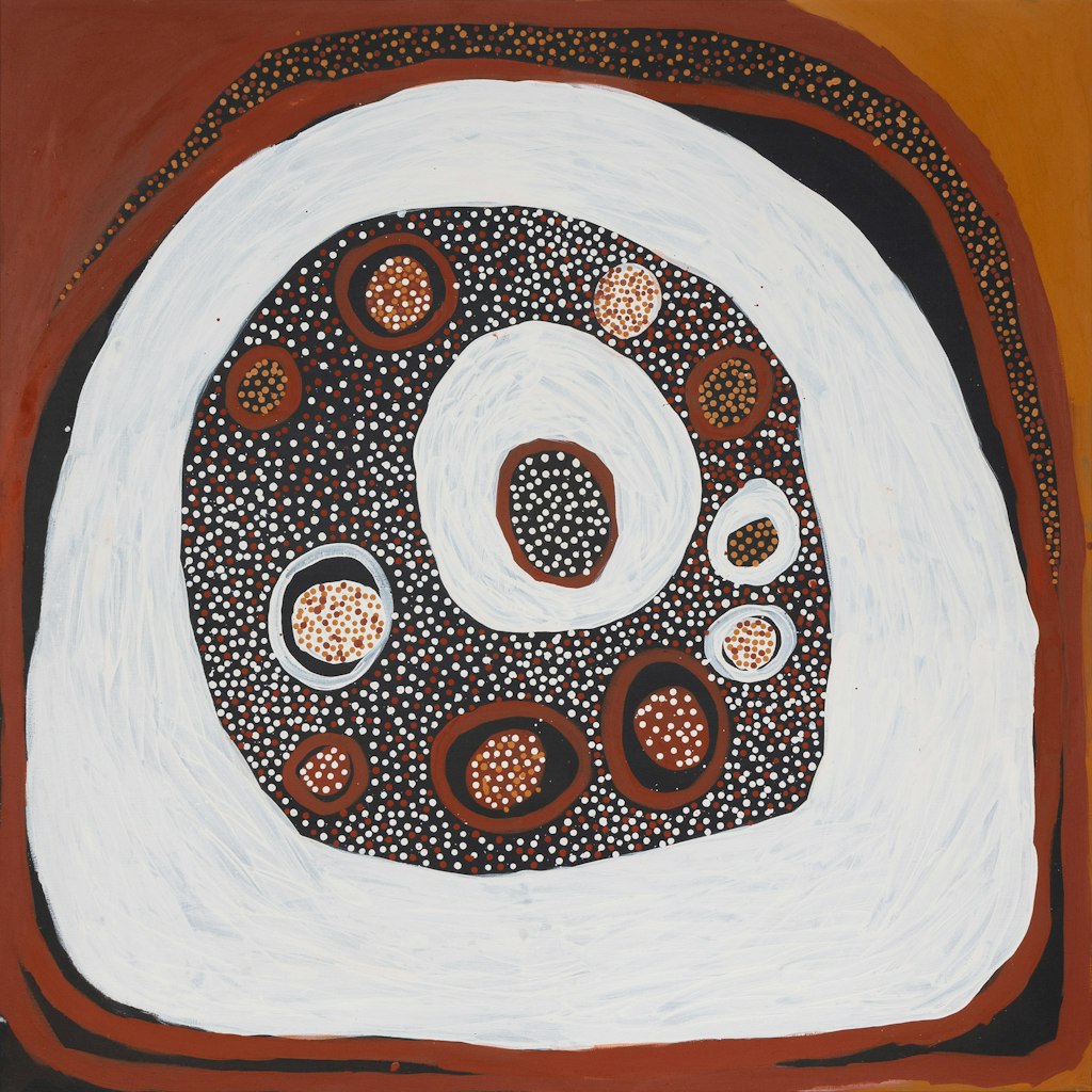 A painting of circular forms in various sizes and tones of brown, black and white