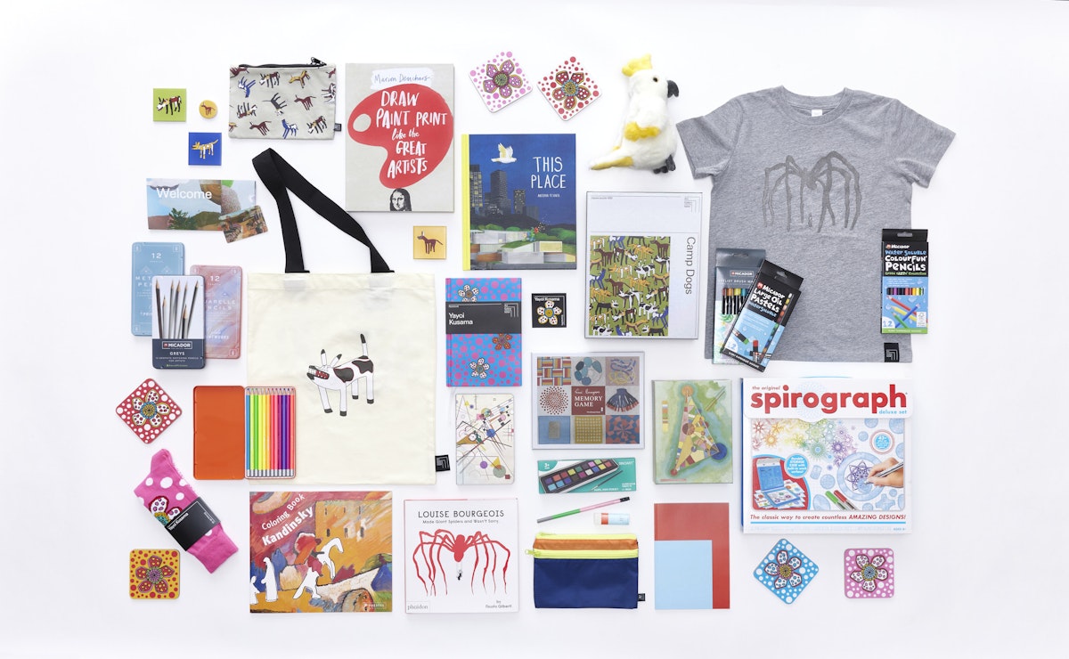 An arrangement of objects including books, art materials, a tshirt, socks, bags and more