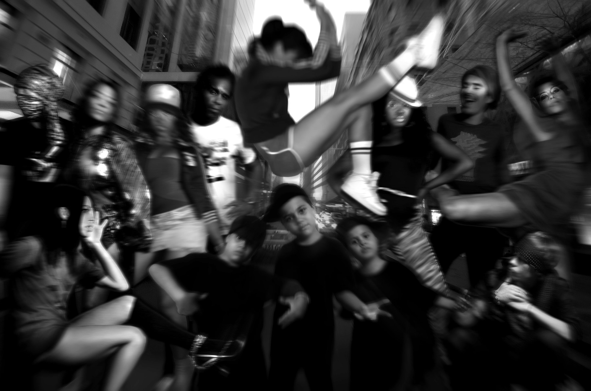 A black-and-white montage of people in various poses surrounded by high-rise buildings