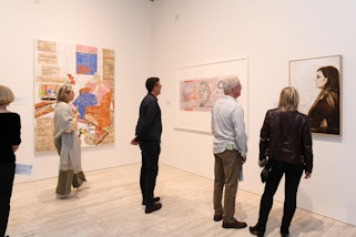 Visitors to Archibald, Wynne and Sulman Prizes 2023 with portraits by (left to right) Katherine Hattam, Ryan Presley and Danie Mellor, photo: Belinda Rolland