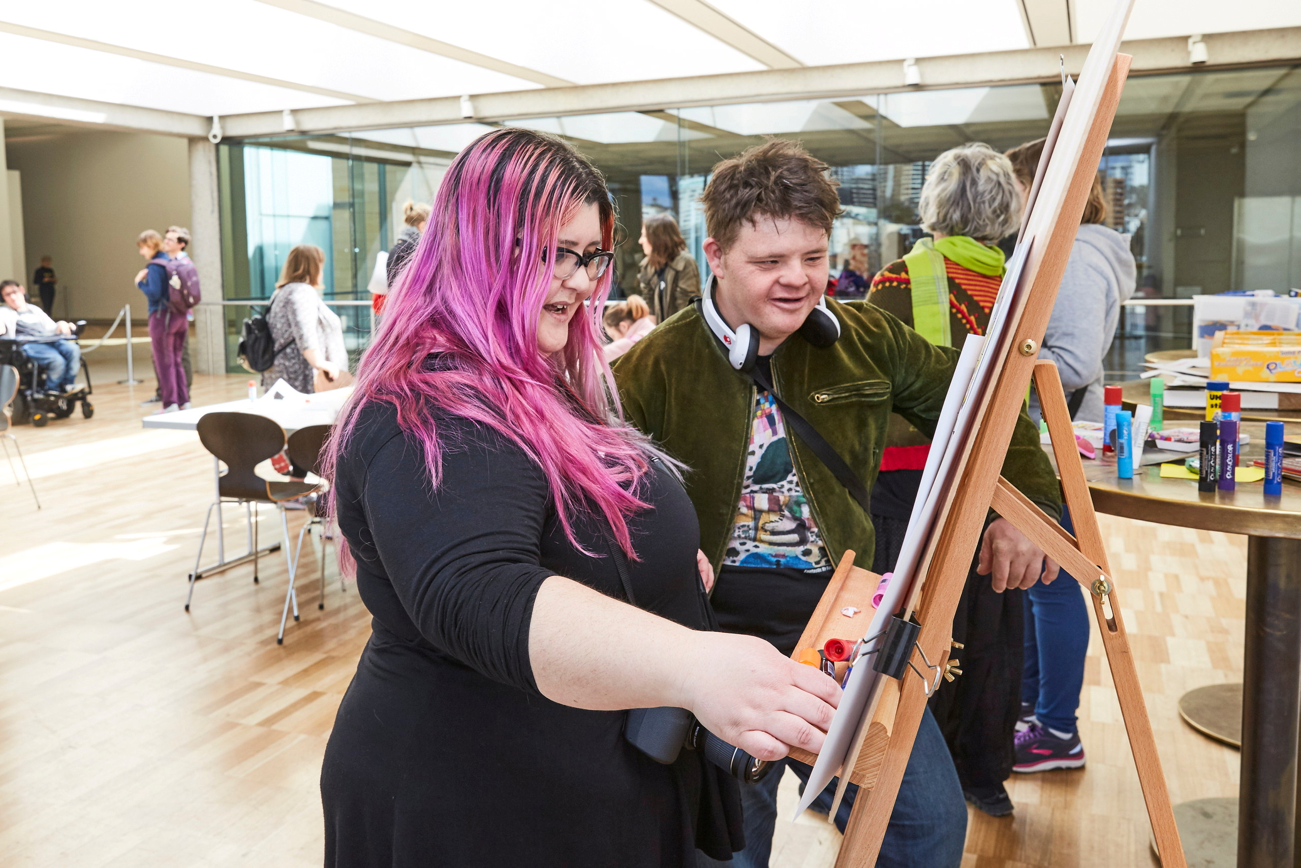 Two people at an easel