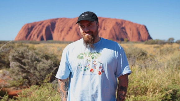 Man standing in front of Uluru