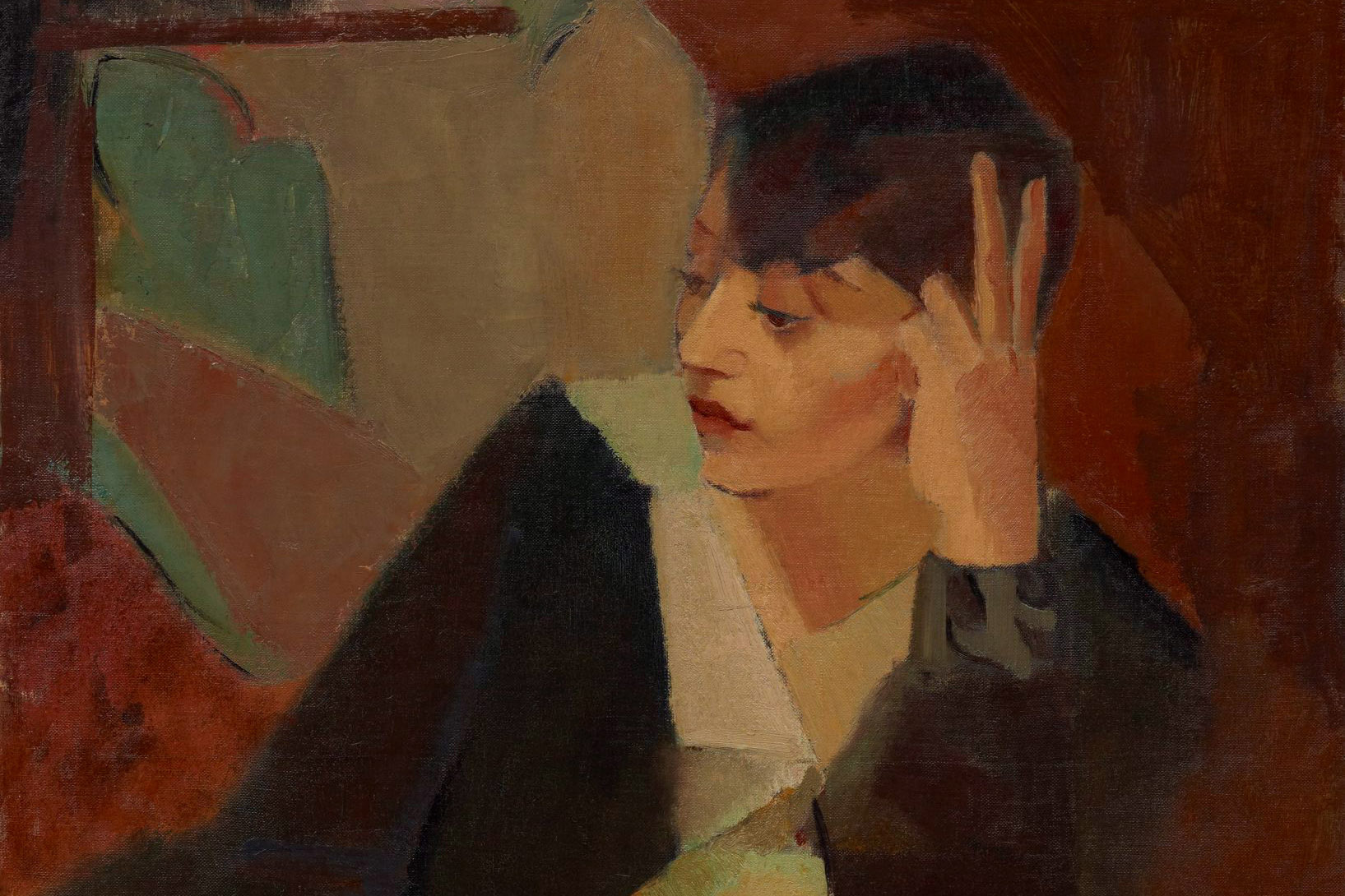 A woman with short hair rests her head against her hand