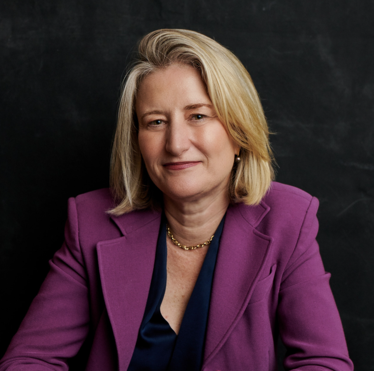 Headshot of a woman against a black background
