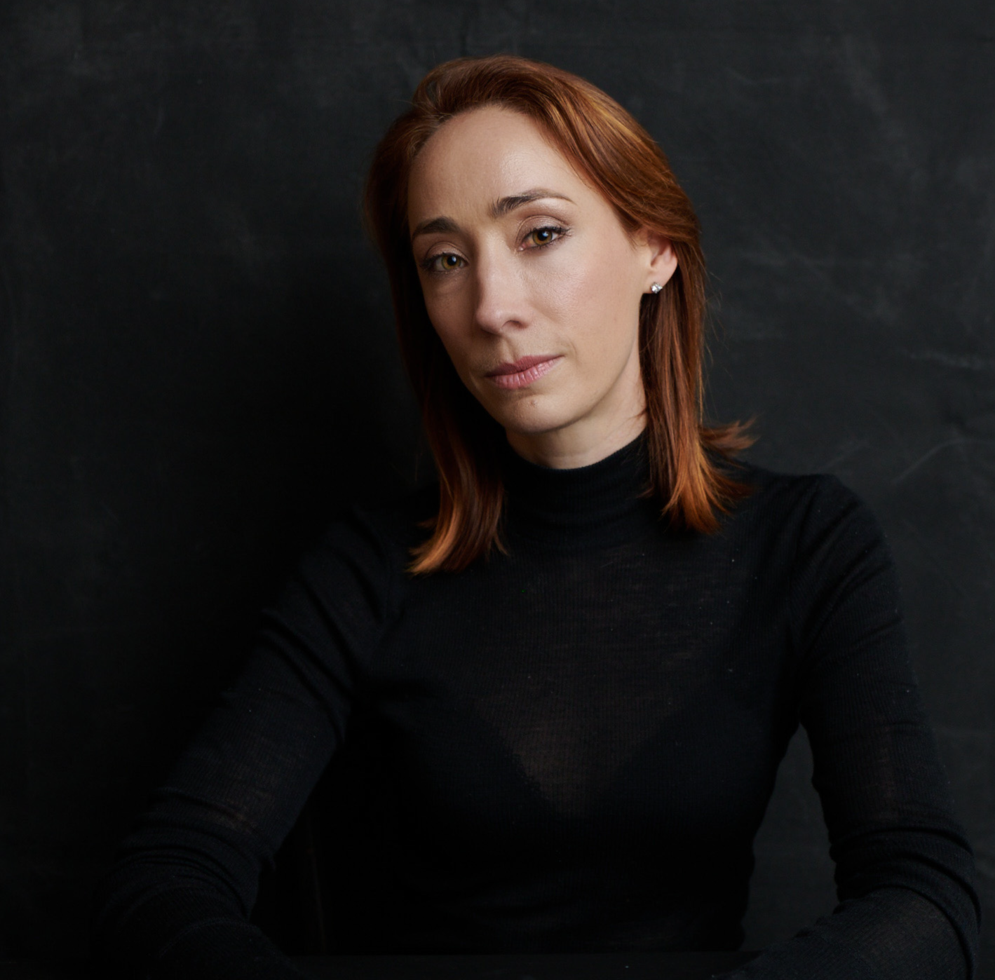 Headshot of a woman against a black background