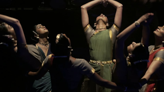Women dressed in traditional attire performing a dance.