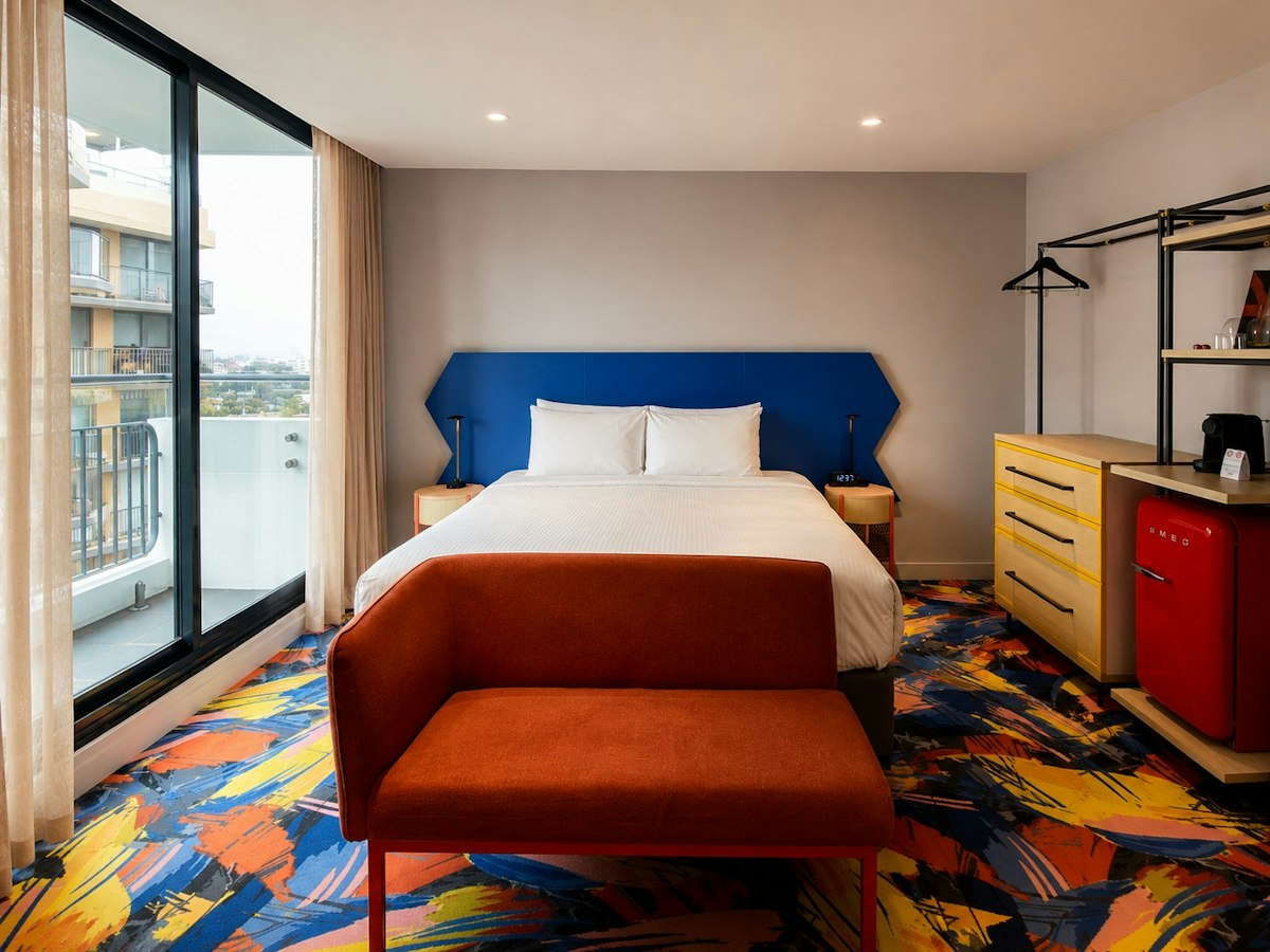 A room with a bed and colourful floor