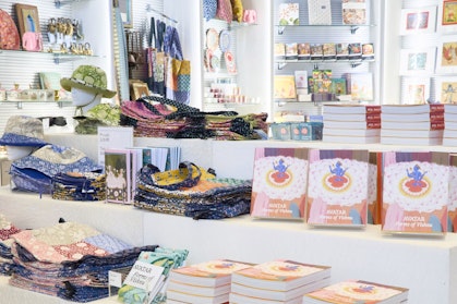 A gallery shop with a range if items displayed on shelves.