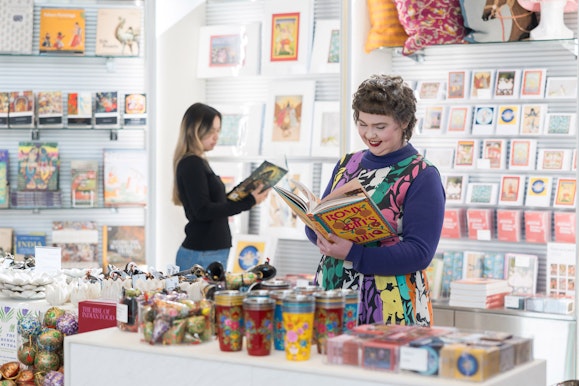 A gallery shop with a range if items displayed on shelves.