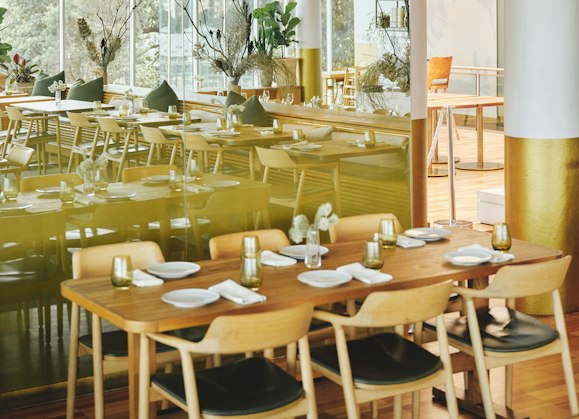 Restaurant interior featuring tables and chairs