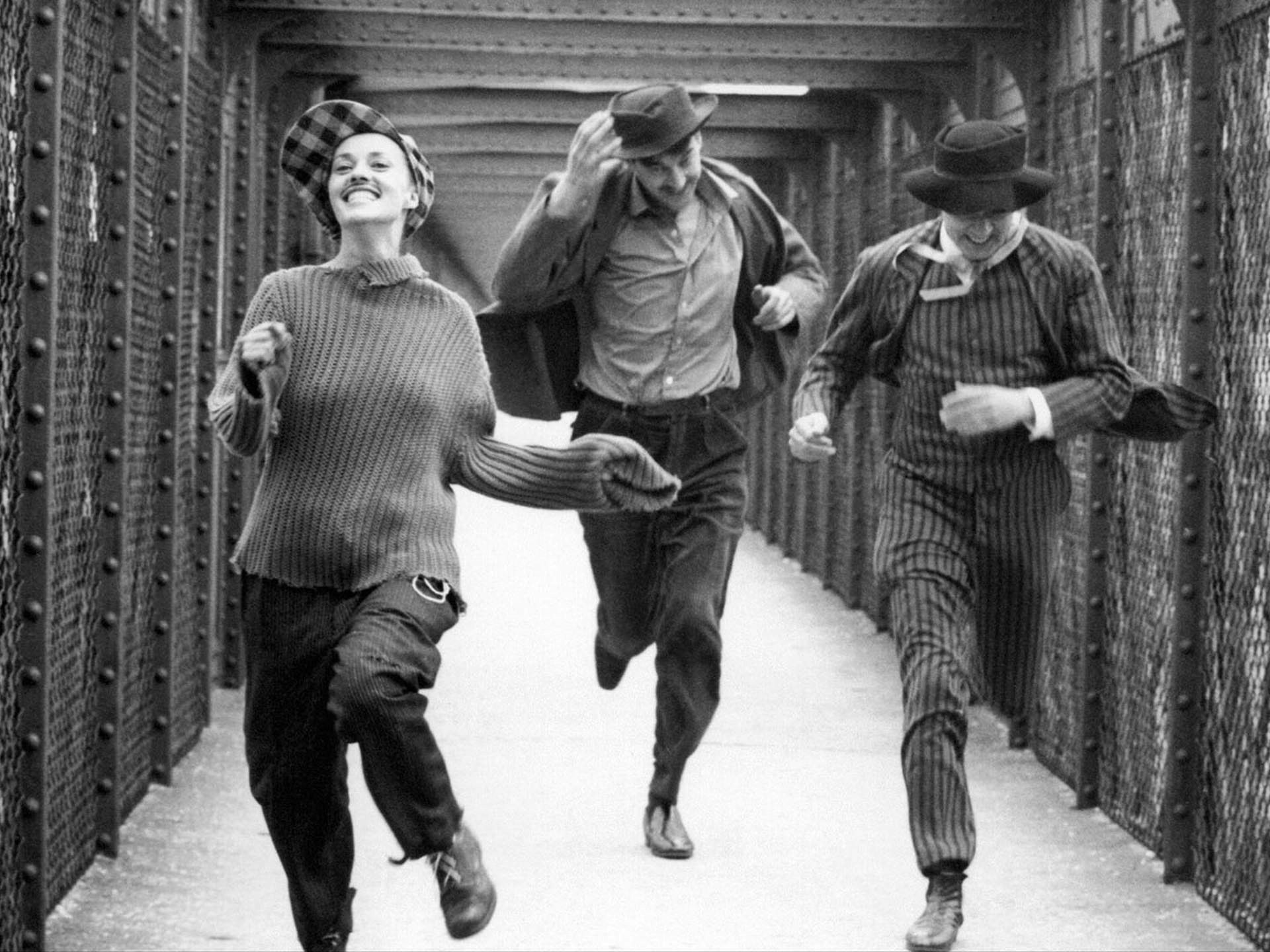 Three people running gleefully.