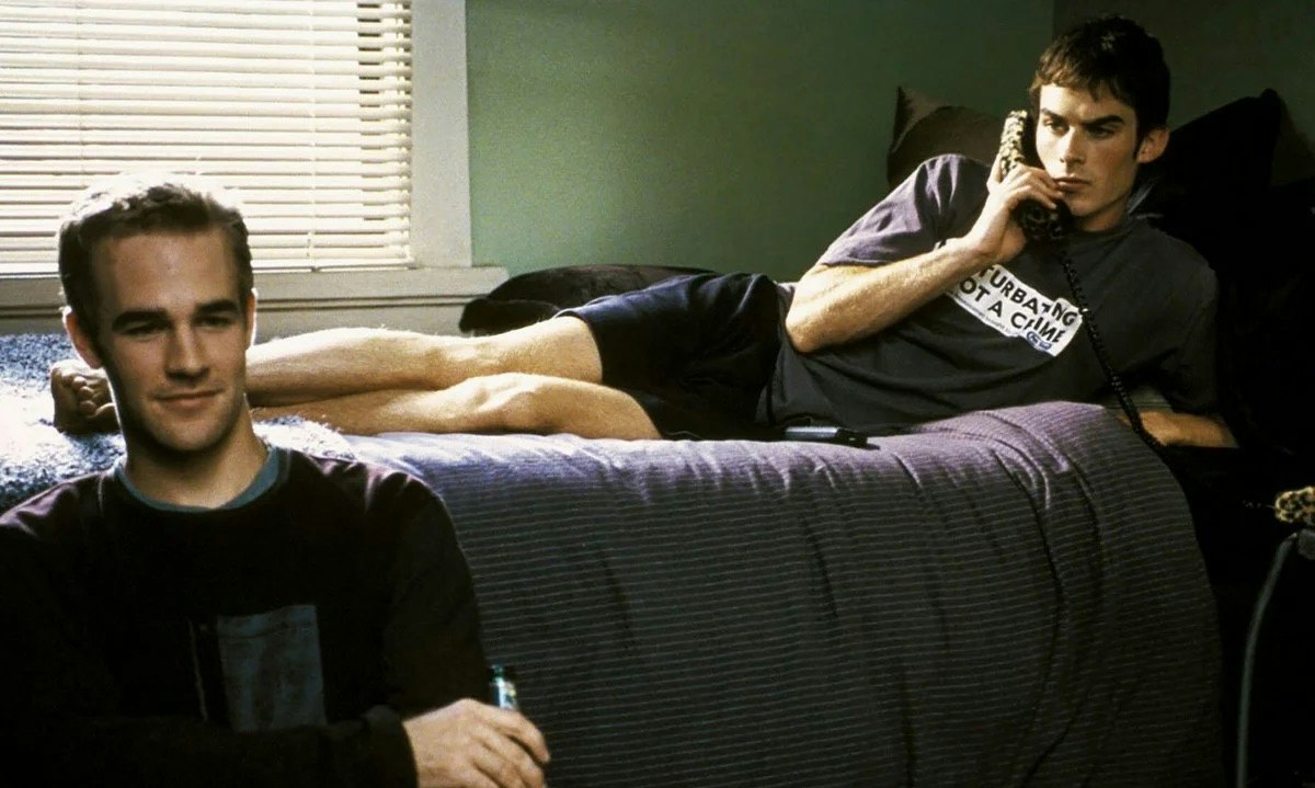 Two college students in a dorm room.