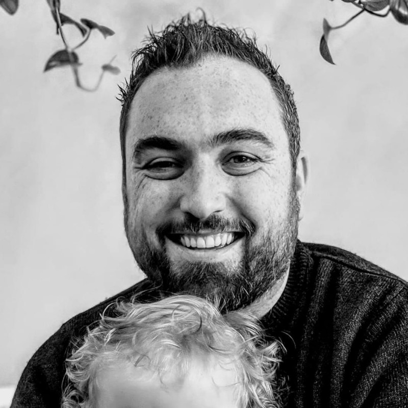 me, at a cafe, holding (not my) baby