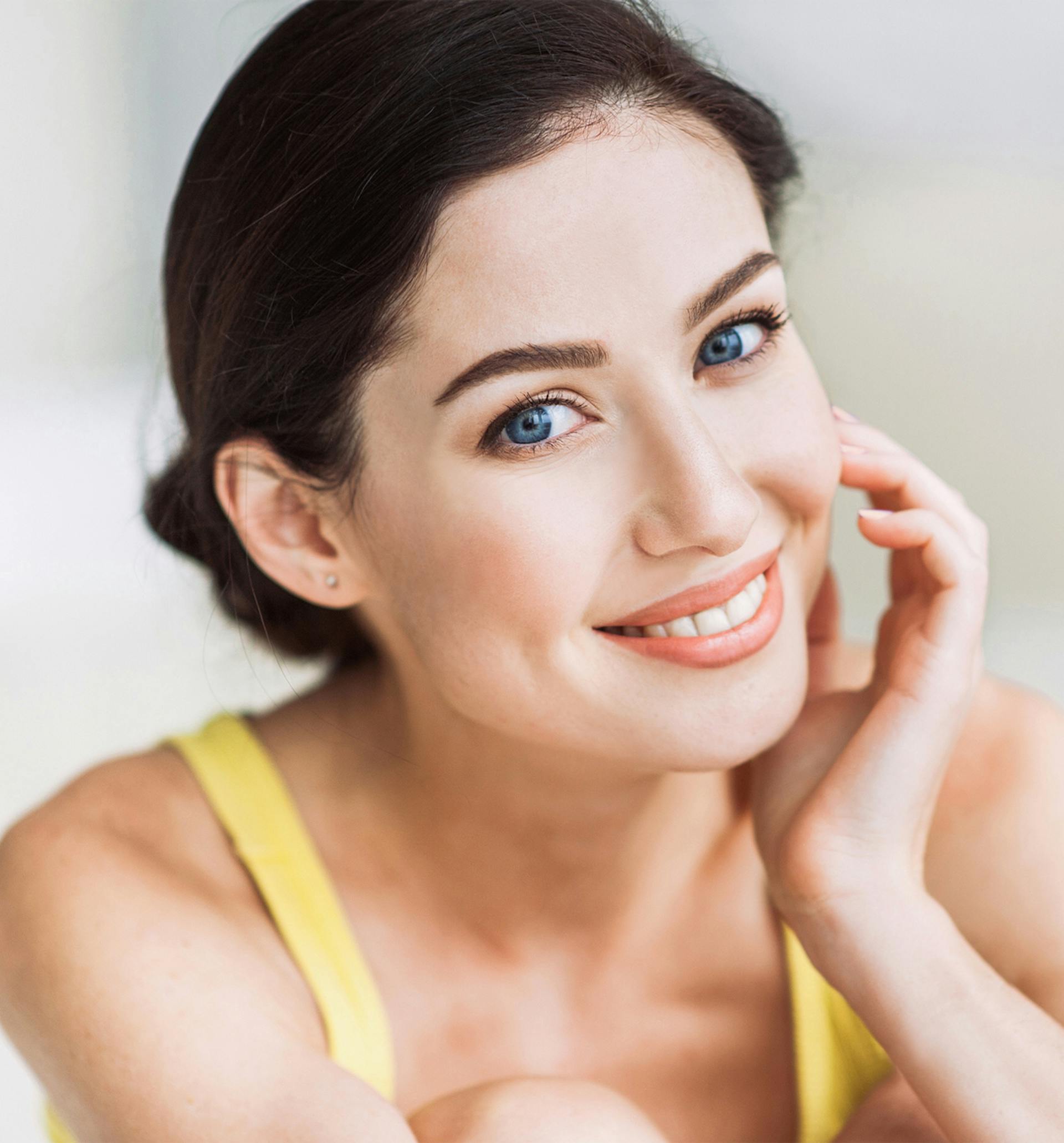 Pretty Women With Blue Eyes And Dark Color Hair Giving A Warm Smile