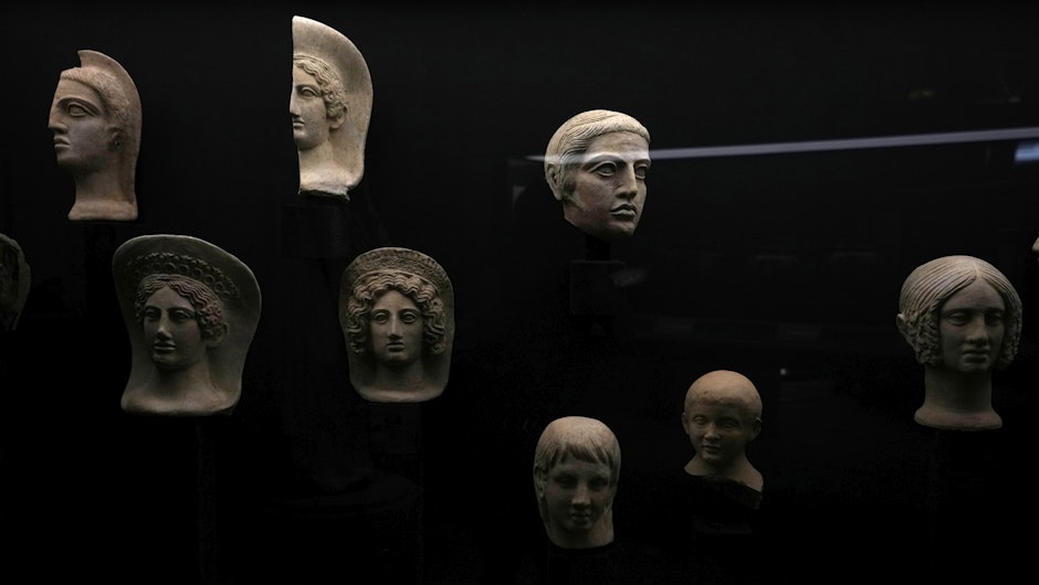Capete și jumătăți de capete votive din teracotă din secolele III și IV î.Hr. expuse la Muzeul de Artă Salvată
