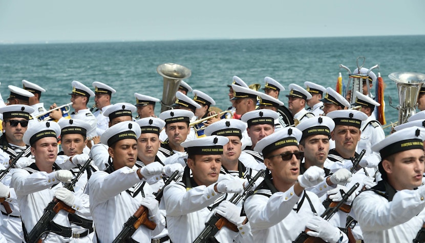 marinari defileaza in uniforme pe litoral