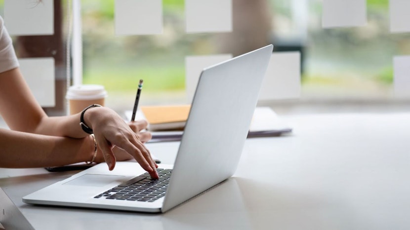 o femeie scrie pe laptop