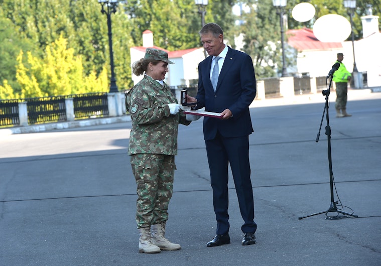 Momentul când Iohannis îi înmânează drapelul de luptă Florentinei Ioniță, la aniversarea a 190 de ani de existență a Spitalului Militar Central
